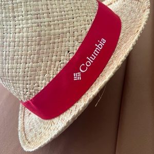 Straw hat with red details.